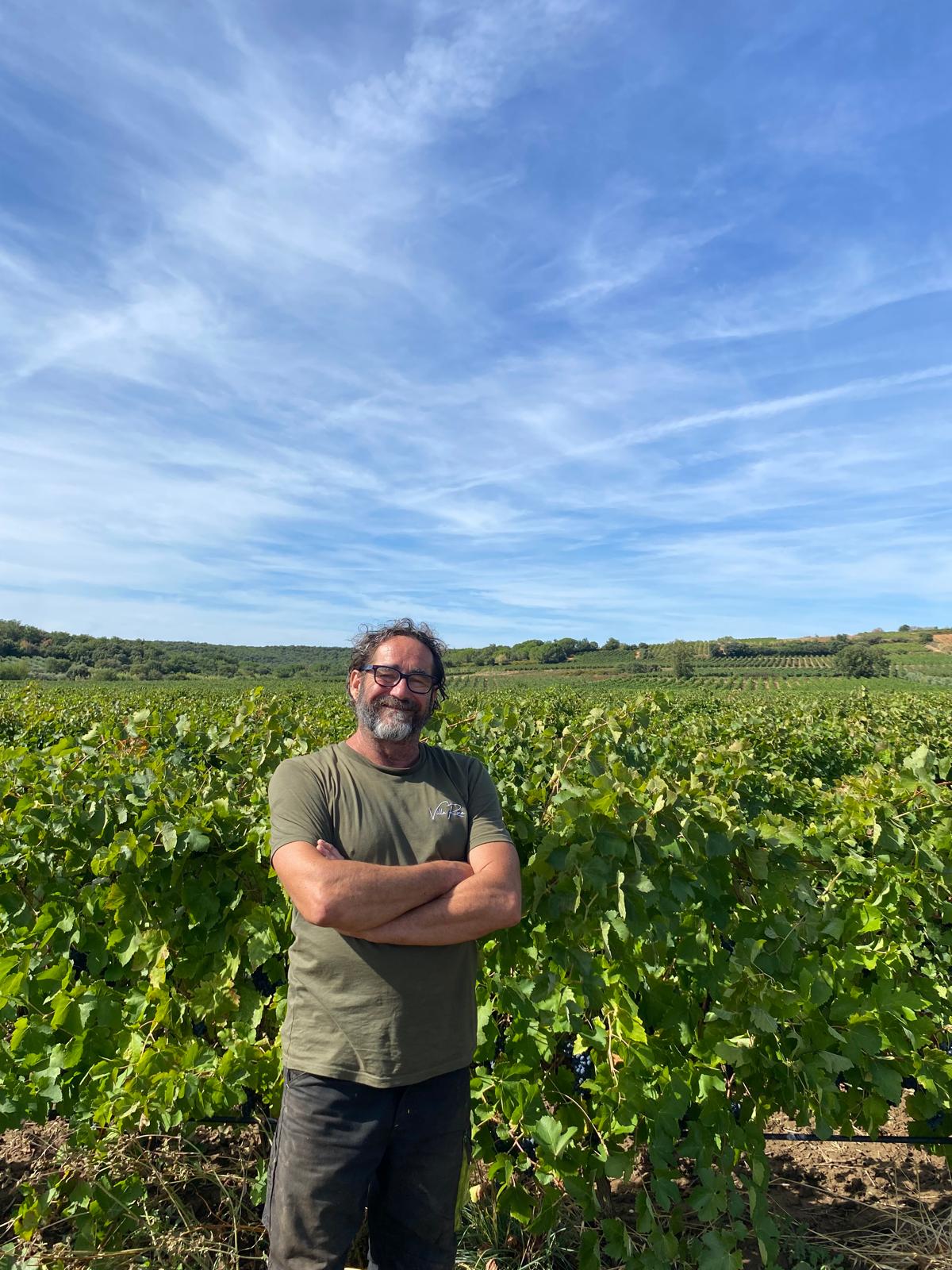 Photo of JP outside next to a sprayer